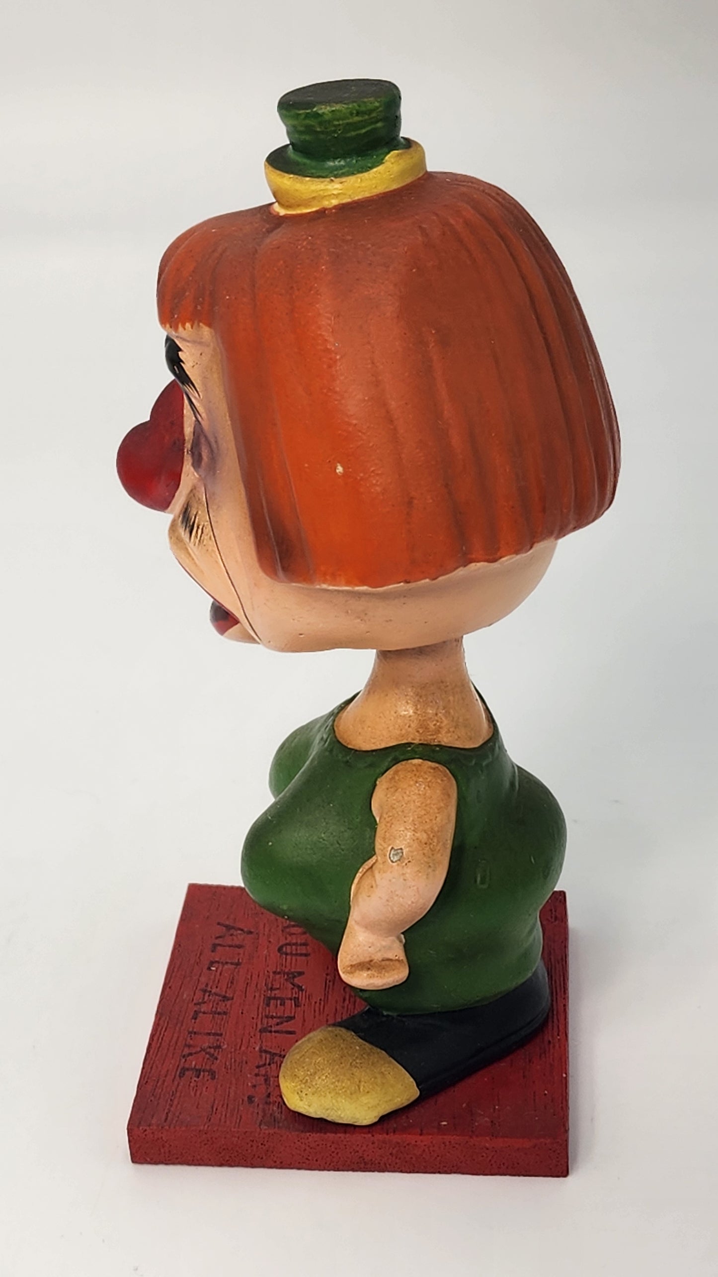 Rumpus Room bobblehead base close-up showing YOU MEN ARE ALL ALIKE embossed lettering