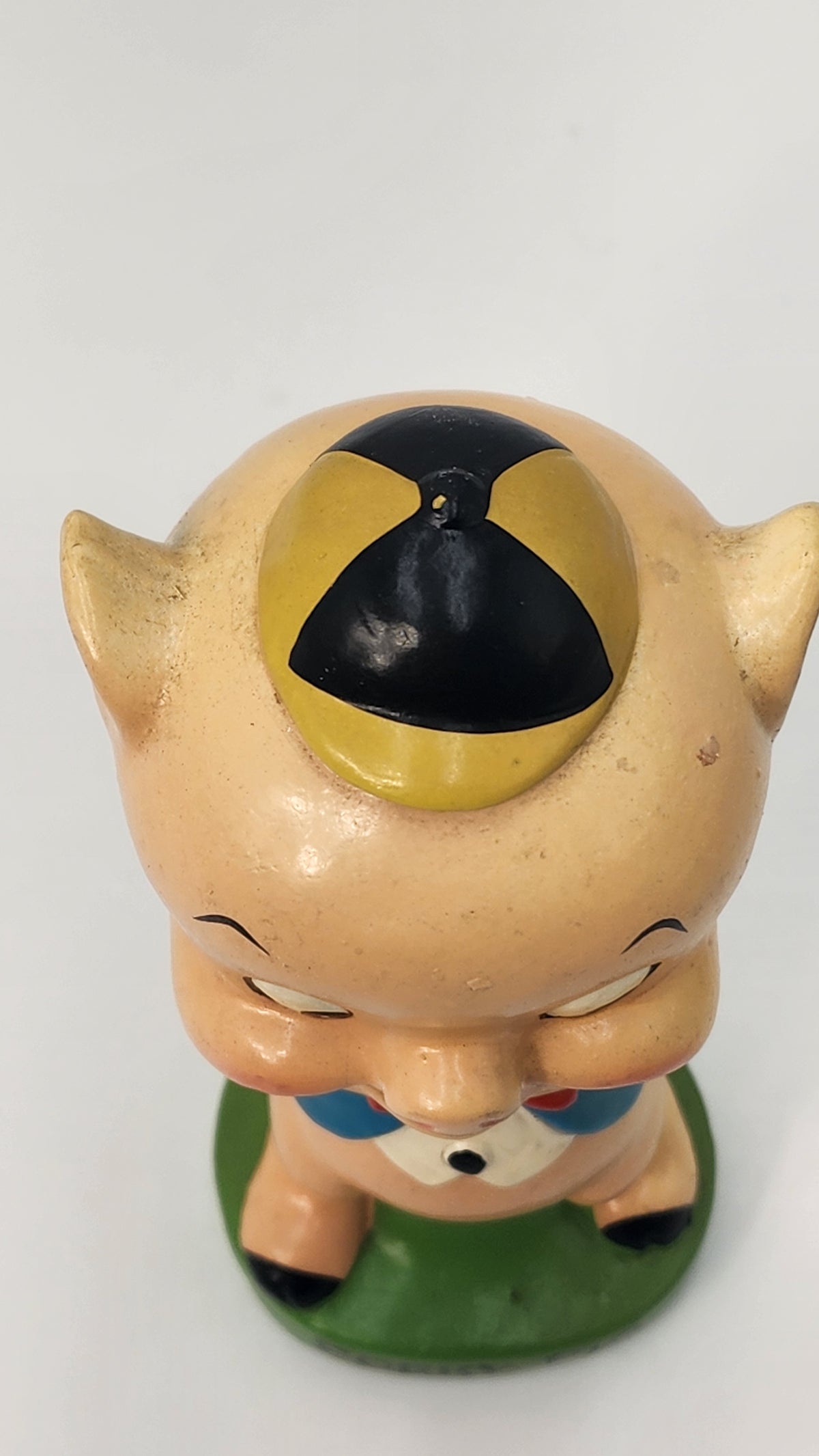 Close-up of Porky Pig bobblehead head and spring