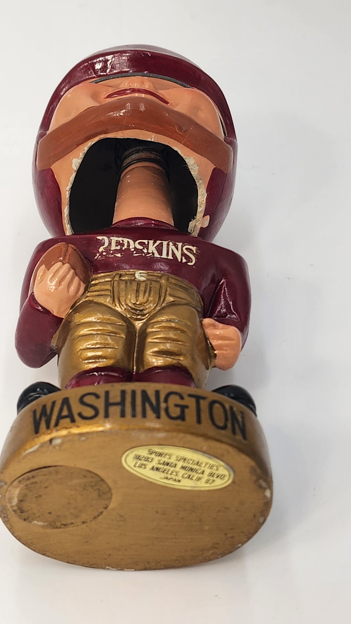 Underside of gold Washington base showing labels